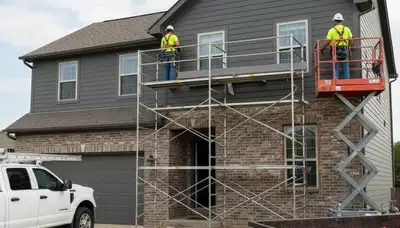 Kansas City, MO siding contractor installing durable vinyl siding on a home